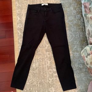 Black stretch denim jeans. Medium rise